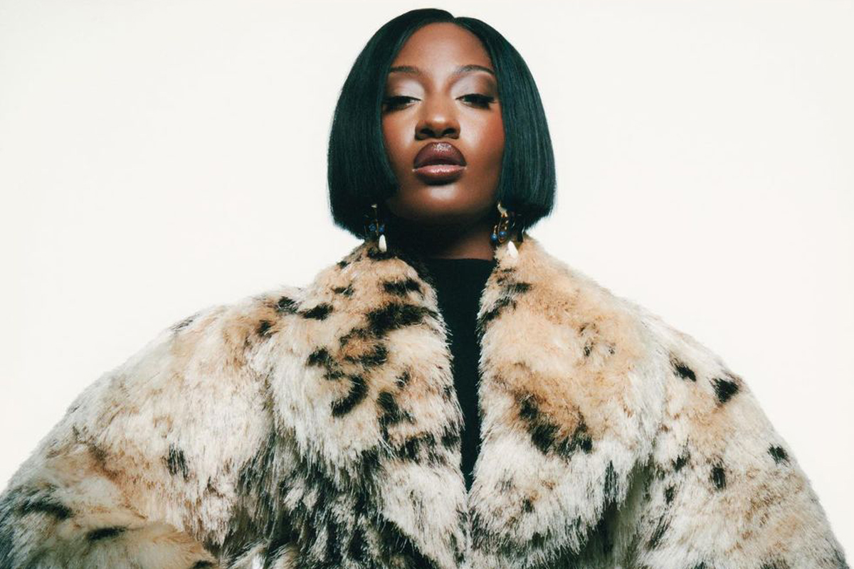 Tems poses in a high fashion garment