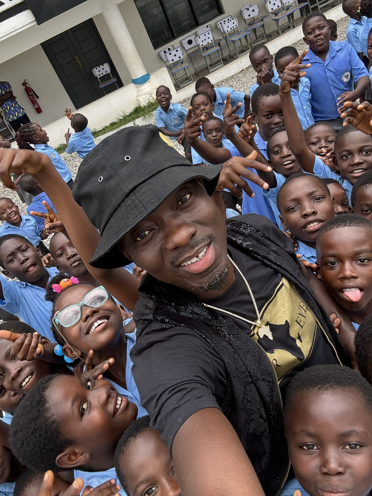 Michael Blackson  with students from the Michael Blackson Academy in Agona Nsaba, Ghana.